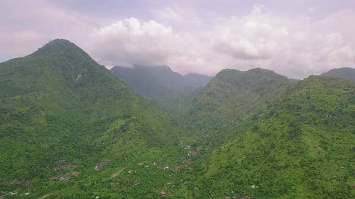 Breathtaking Mountains Covered with Tropical Lush Aerial View on Dramatic Day.