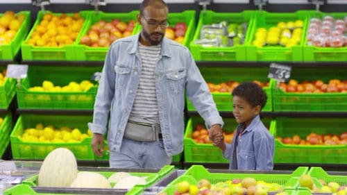 Father and Son Shopping for Food at Supermarket