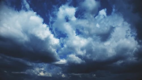 Dramatic Storm Clouds Moving across Blue Sky