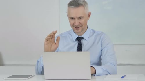 Online Video Chat By Senior Businessman at Work
