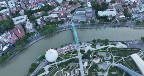 Aerial view of Tbilisi city central park and Bridge of Peace. Beautiful cityscape of old Tbilisi at