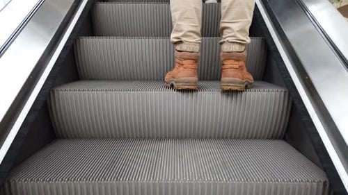 The Man Walks up the Escalator