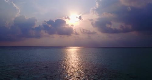 Wide birds eye clean view of a white paradise beach and aqua blue ocean background in colourful