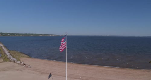 American Flag Waving at Beach on Sunny Day