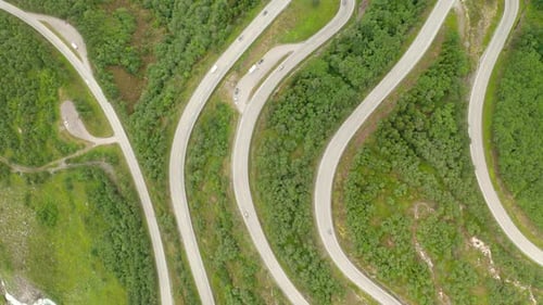 Serpentine Mountain Road With Vehicles Driving In Stryn, Vestland, Norway. aerial top-down