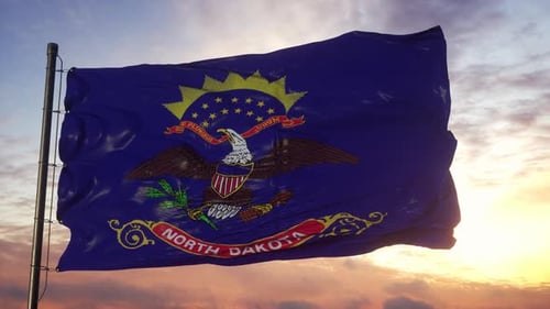 Flag of North Dakota Waving in the Wind Against Deep Beautiful Sky at Sunset