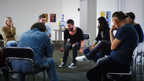 Adults in Group Therapy Session Offering Support