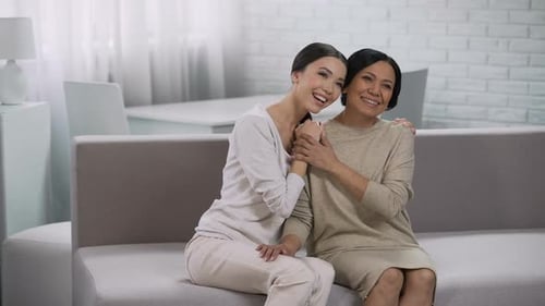Two Women Happily Communicating Smiling and Embracing Trust in Relationship
