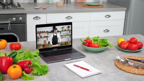 Fresh Vegetables and Cooking Tutorial on Laptop