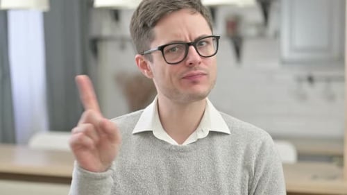 Man Shaking Head and Raising Finger to Say No