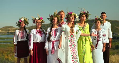 Adults Singing Together in Traditional Clothing and Crowns