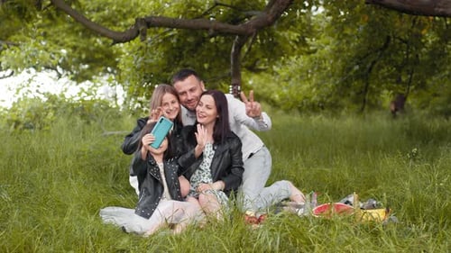 Happy Family Taking Selfie on Picnic in Park