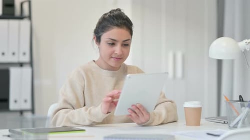 Woman Works at Desk With Tablet