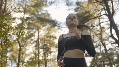 Beautiful Sportswoman Running in Headphones