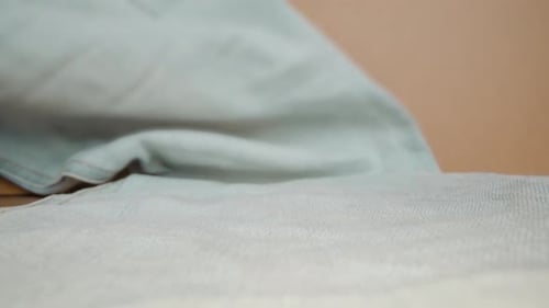 Denim Pants with Yellow Stitching Against Beige Studio Wall