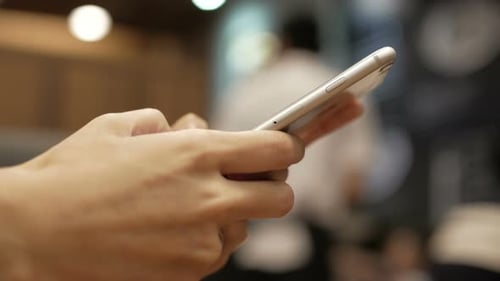 Woman's Hands Using Mobile Phone Close Up