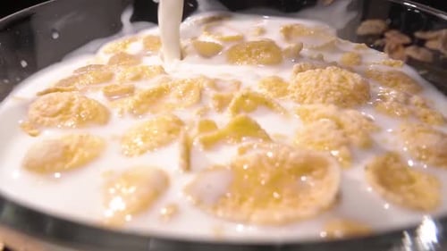 Milk Pouring Into Bowl of Cereal Close Up