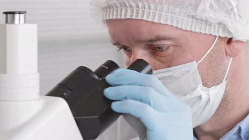 Man Looking through Microscope