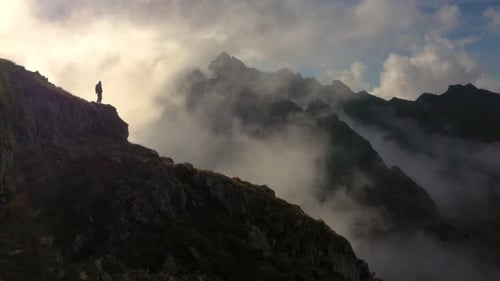 Amazing Hiker Near the Edge of a Mountain