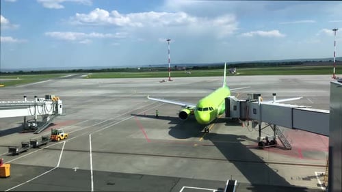 The Boarding Bridge is Moves to Aircraft at Sunny Day