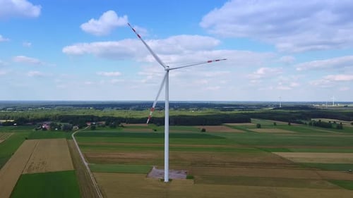 Wind Turbine Spinning in Green Rural Landscape