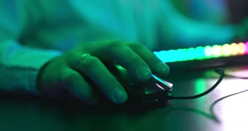 Fingers of a Man’s Hand Lie on a Computer Mouse