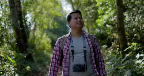 Young Man walking in Forest trail with Hiking concept