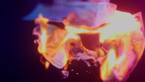 Money Burning Brightly With Pink and Blue Hues