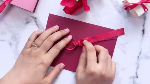 Love Letter in Women Hand on White Background , Top View.