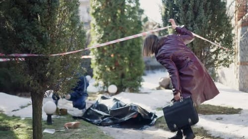 Crime Scene Investigation Near Body Covered in Black Tarp