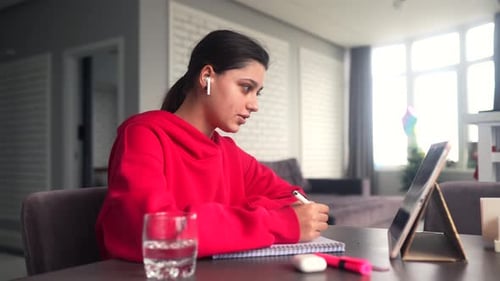 Beautiful Caucasian Female Student is Studying in College Remotely