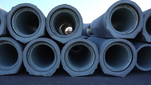 Motion Along Concrete Pipes to Install at Construction Site