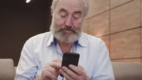 Senior Man Using Smartphone Appears Confused