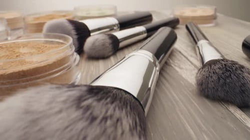 Cosmetics and Beauty Concept. Brush for Make-up with Powder on a Wooden Table