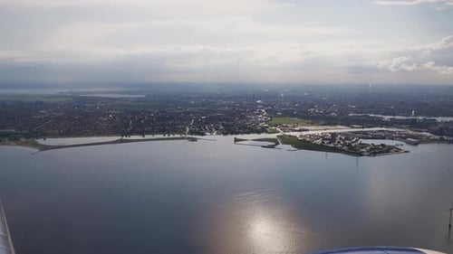 View Through Plane Window on Beautiful Scenery While Taking Off and Climbing