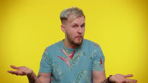Confused Man Gesturing on a Yellow Background