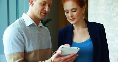 Executives discussing over digital tablet in office