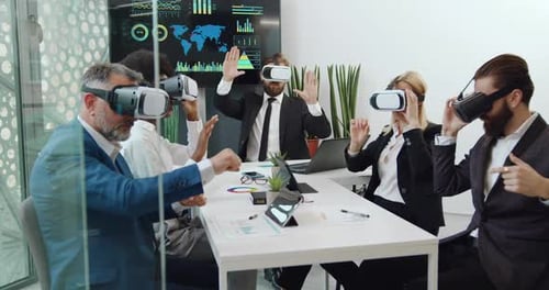Business People Use VR Headsets in Office Meeting