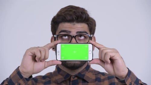Man Holding Smartphone with Chroma Key Display