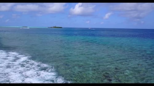Aerial flying over scenery of exotic sea view beach vacation by aqua blue lagoon and white sand back