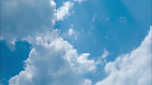 Time lapse of the blue sky in summer day. Blue sky white clouds. White clouds background.