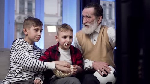 Grandfather and Boys Watch TV, Eat Popcorn