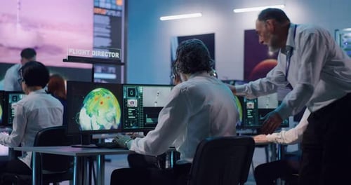 Senior Man Helping Colleague During Rocket Launch