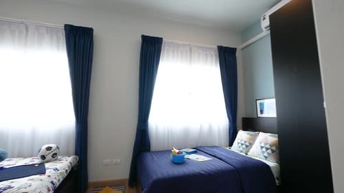 Brightly Lit Child's Bedroom With Beds