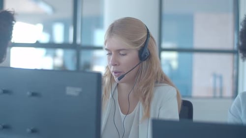 Serious Young Female Operator Headset Talking To Customer