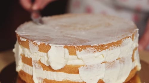 Close-up of Creamy Cake on a Rotating Plate, Cook Is Touching It By Scoop