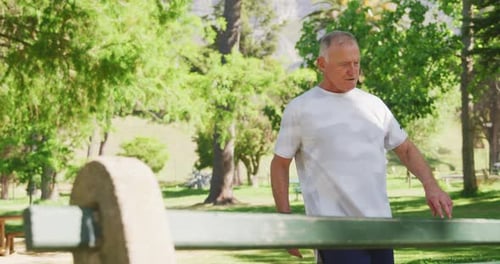 Senior man stretching his legs in the park