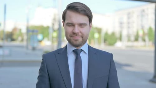 Man in Suit Smiling in Urban Setting