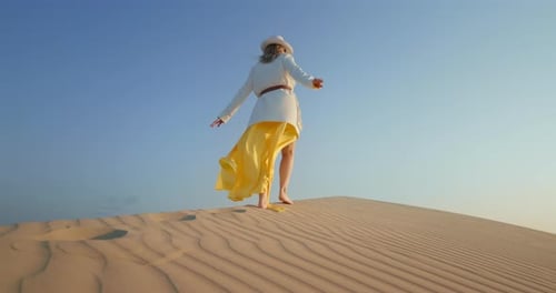 Woman Walking on Sand Dune Barefoot
