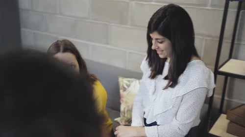 Coworkers Meet in Modern Office to Review Tablet